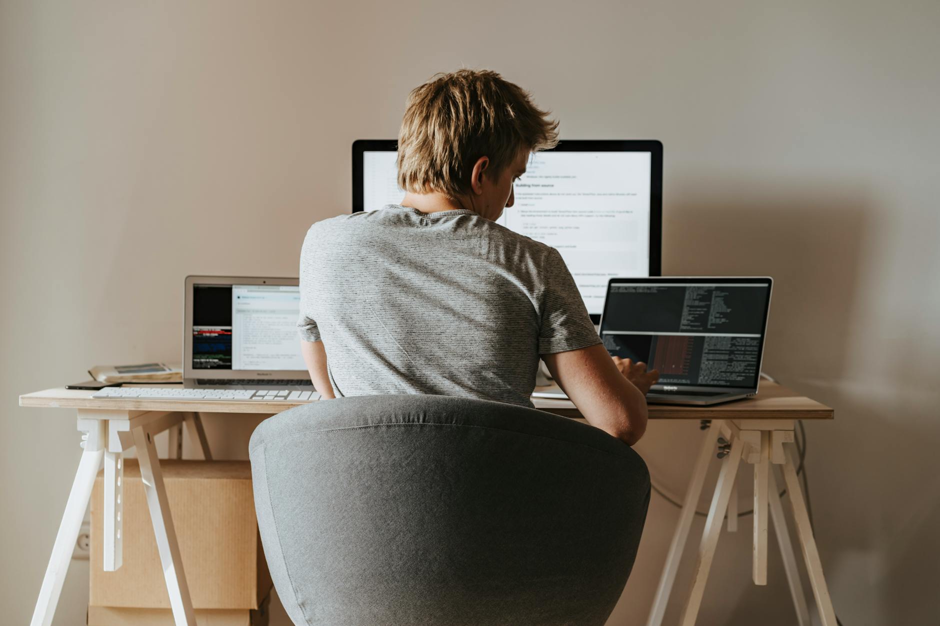 Person coding at a home office setup — remote AI career opportunities