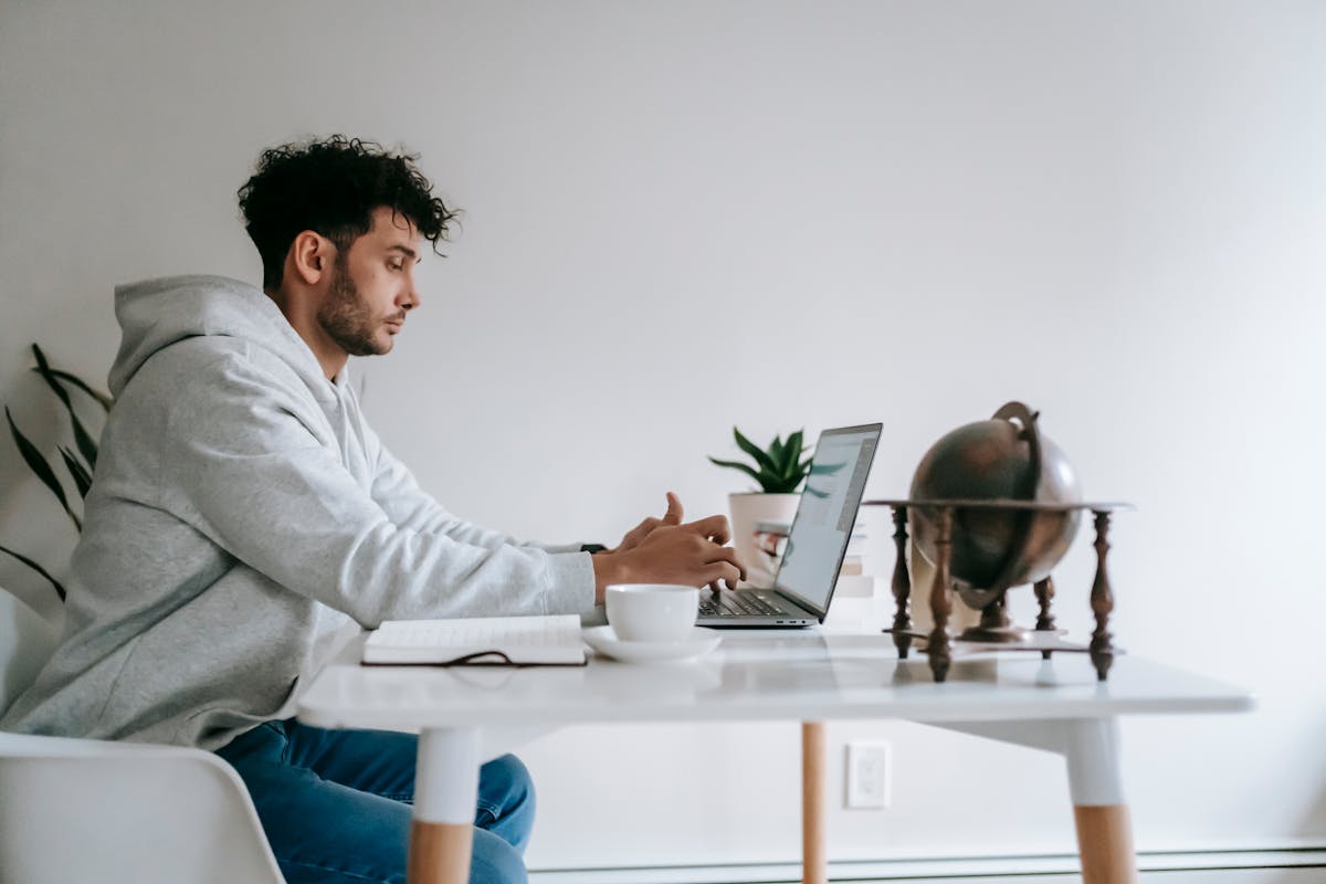 Person working at home on a laptop, representing remote AI training work
