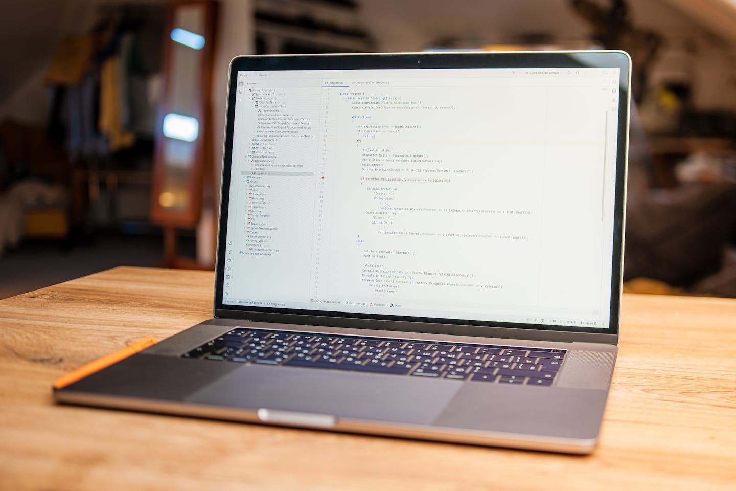 Modern laptop displaying code in a cozy workspace setup