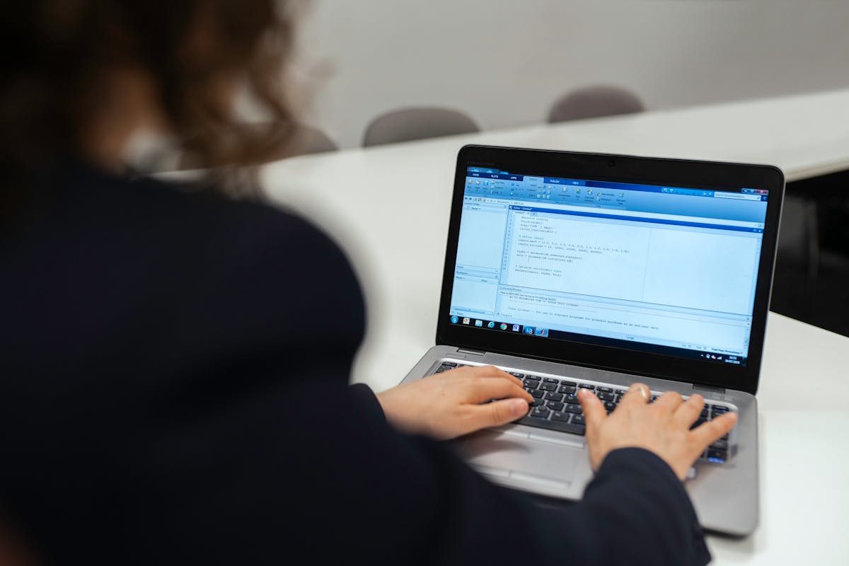 Software developer focused on coding at a workstation — building AI agent systems remotely