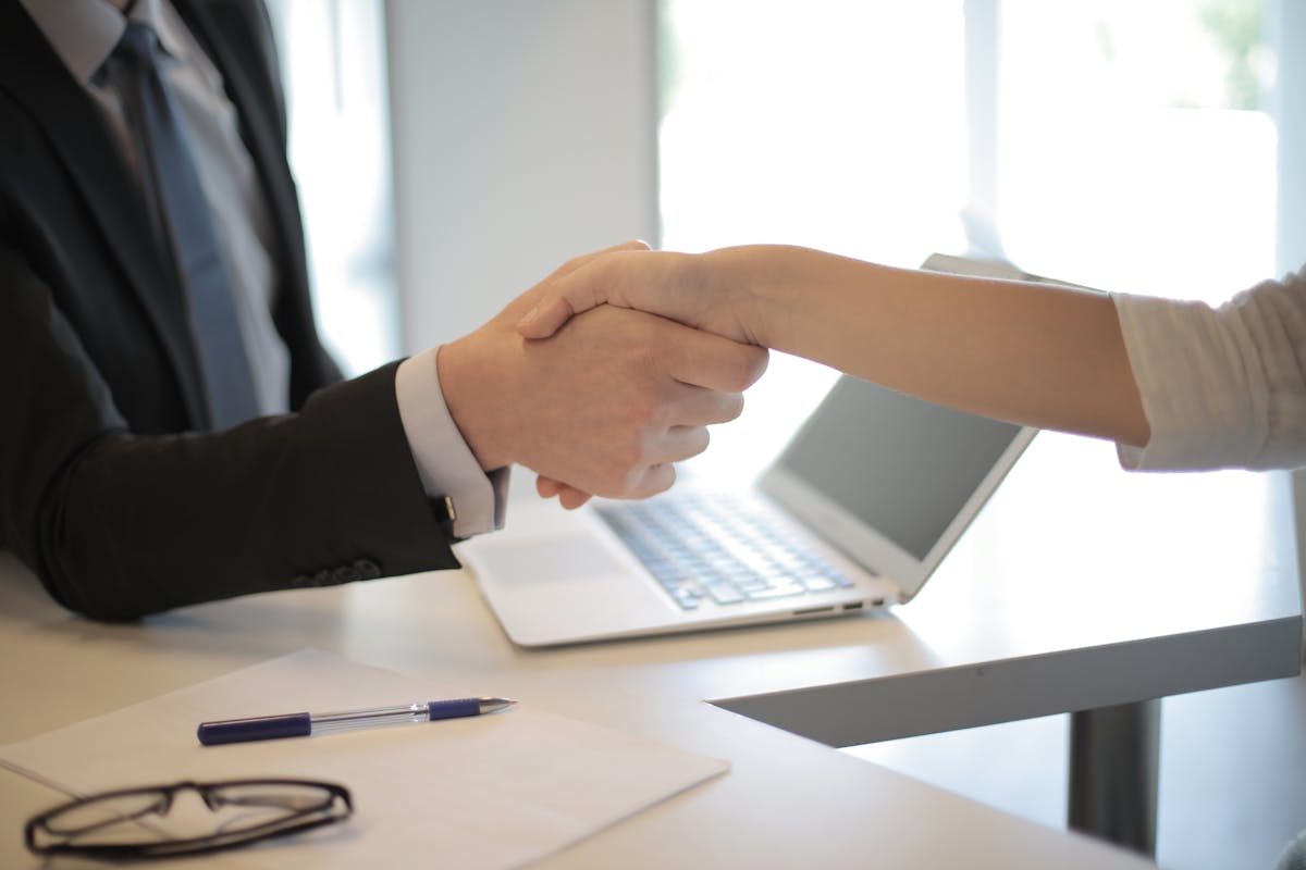 Professional handshake during a hiring meeting in a modern office